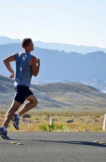 Person running on a scenic road