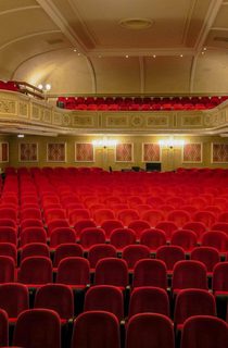 Empty red seats in a theatre