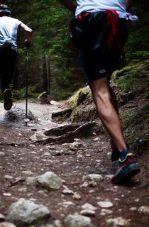 Two people running on a trail