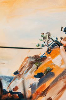 Woman painting a nature scene outside