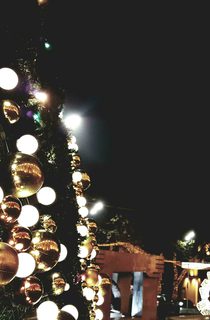 Gold and silver baubles displayed on the wall of an outdoor display