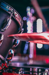 Black acoustic drum set with shiny hi hat