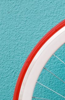 Bicycle wheel against a bright wall