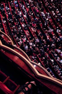 Audience sitting in a performance theatre